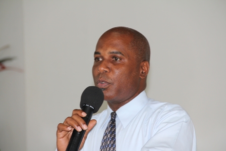 Permanent Secretary in the Ministry of Social Development and Youth on Nevis Mr. Alsted Pemberton addressing youths at the Creativity for Employment and Business Opportunity Youth Training Workshop at the Cotton Ground Community Centre